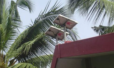 Photo: 2 solar panels on roof with palm trrees